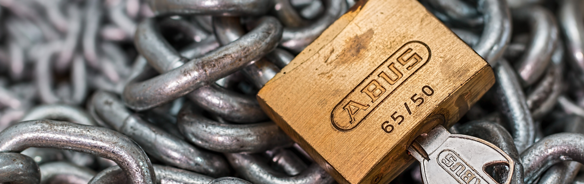 Close up of padlock with chains in the background - Link to Locking Devices & Reproduction of Keys